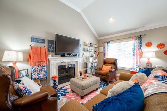 living room featuring lofted ceiling, crown molding, a tile fireplace, and baseboards