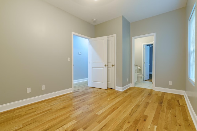 11 Woodvale Ave, Chattanooga, TN 37411 - unfurnished bedroom featuring light wood-style floors, connected bathroom, and baseboards