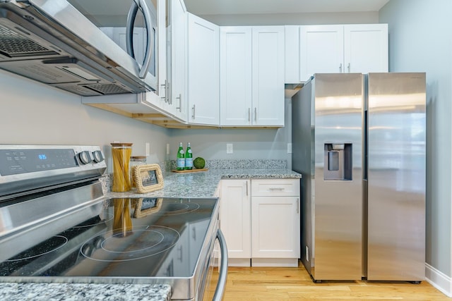 11 Woodvale Ave, Chattanooga, TN 37411 - kitchen with stainless steel appliances, white cabinetry, and light wood-style flooring