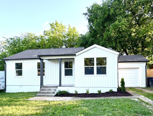 modern farmhouse style home featuring a shingled roof, a front lawn, a garage, crawl space, and board and batten siding