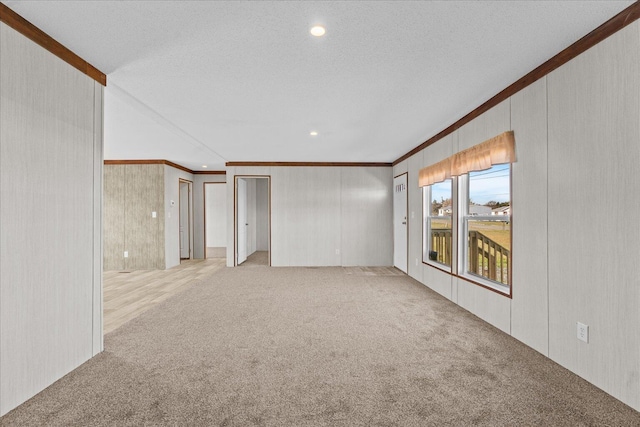 carpeted spare room featuring crown molding and recessed lighting