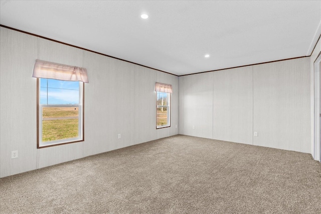 carpeted empty room featuring ornamental molding and recessed lighting