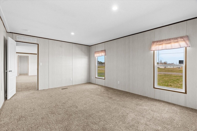 carpeted empty room featuring recessed lighting