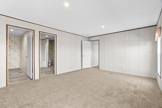 unfurnished bedroom with carpet flooring, crown molding, ensuite bath, and recessed lighting