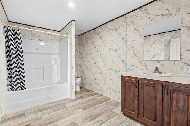 bathroom with toilet, vanity, shower / bath combo with shower curtain, and wood finished floors