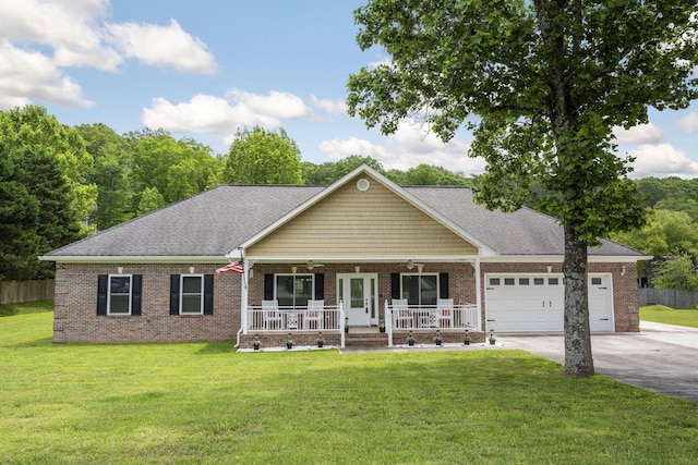 12204 Plow Ln, Soddy Daisy, TN 37379 - view of front facade with covered porch, driveway, an attached garage, and brick siding