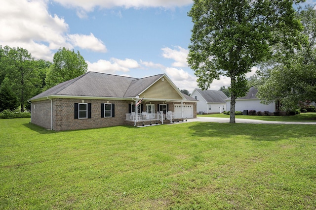 12204 Plow Ln, Soddy Daisy, TN 37379 - view of front of home with covered porch, driveway, an attached garage, a front yard, and brick siding