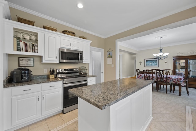 12204 Plow Ln, Soddy Daisy, TN 37379 - kitchen with stainless steel appliances, light tile patterned floors, crown molding, white cabinetry, and a chandelier