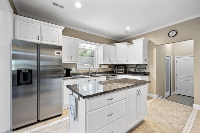 12204 Plow Ln, Soddy Daisy, TN 37379 - kitchen featuring appliances with stainless steel finishes, a sink, light tile patterned flooring, ornamental molding, and a center island