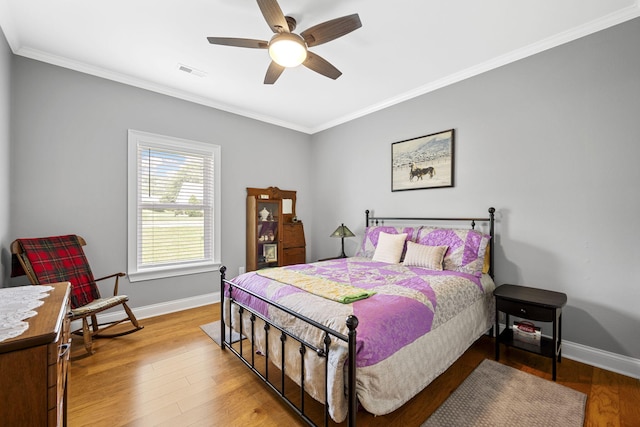 12204 Plow Ln, Soddy Daisy, TN 37379 - bedroom with baseboards, crown molding, wood finished floors, and a ceiling fan