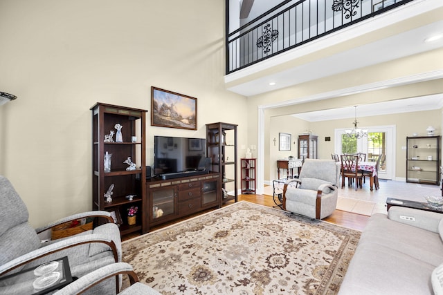 12204 Plow Ln, Soddy Daisy, TN 37379 - living room with crown molding, wood finished floors, baseboards, and a chandelier