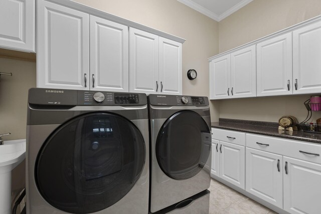 12204 Plow Ln, Soddy Daisy, TN 37379 - laundry room with ornamental molding, washing machine and dryer, cabinet space, and light tile patterned floors