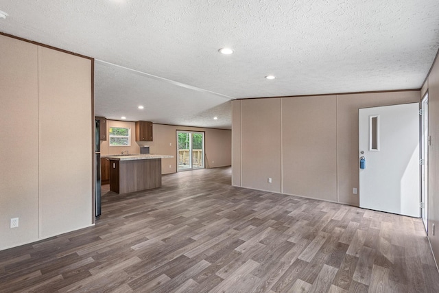 398 Jodie Ln, Dayton, TN 37321 - unfurnished living room featuring wood finished floors, a textured ceiling, and recessed lighting