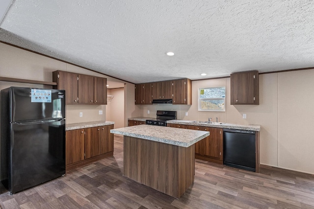 398 Jodie Ln, Dayton, TN 37321 - kitchen featuring black appliances, dark wood finished floors, a textured ceiling, light countertops, and under cabinet range hood