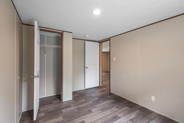 398 Jodie Ln, Dayton, TN 37321 - unfurnished bedroom with wood finished floors, a closet, and a textured ceiling