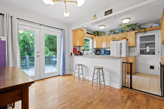 5007 Florida Ave, Chattanooga, TN 37409 - kitchen with light brown cabinets, freestanding refrigerator, french doors, and light wood-type flooring