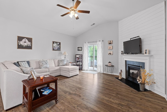 living room featuring vaulted ceiling, ceiling fan, wood finished floors, and a fireplace with flush hearth