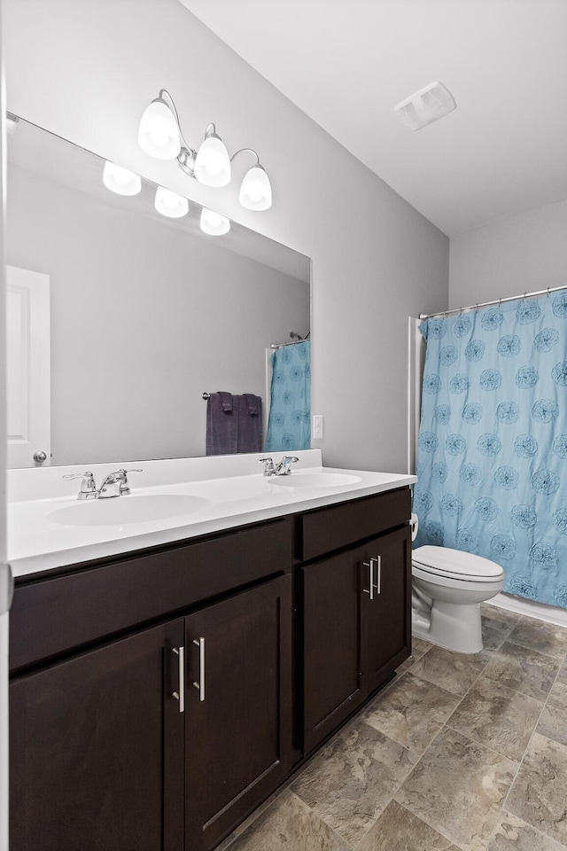 full bathroom featuring double vanity, toilet, and a shower with curtain