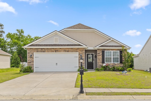 craftsman house featuring a front yard, driveway, a garage, and stone siding
