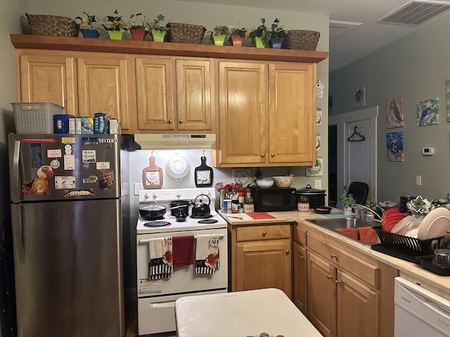 kitchen with white appliances, under cabinet range hood, a sink, and light countertops