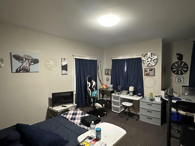carpeted bedroom with an office area