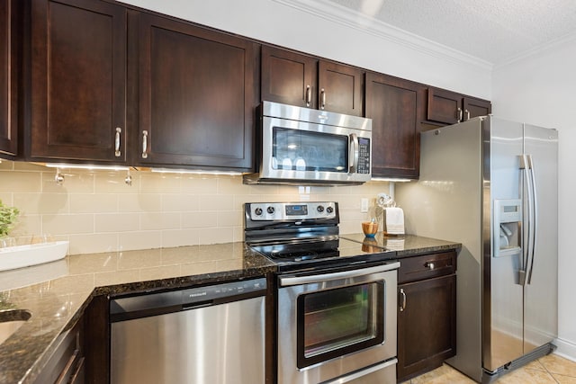 1131 Stringers Ridge Rd Unit 11G, Chattanooga, TN 37405 - kitchen with stainless steel appliances, dark brown cabinets, backsplash, dark stone counters, and ornamental molding
