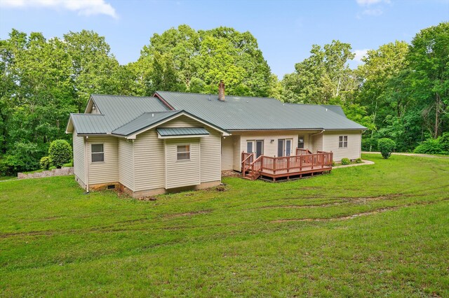 6601 Hunter Rd, Harrison, TN 37341 - rear view of property featuring a deck, a lawn, metal roof, and a chimney