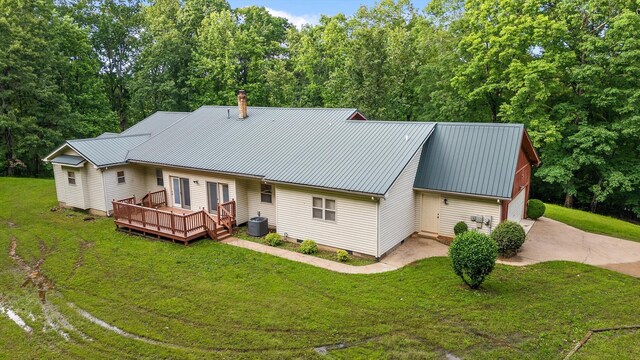 6601 Hunter Rd, Harrison, TN 37341 - back of house featuring central AC, a wooden deck, a lawn, and metal roof