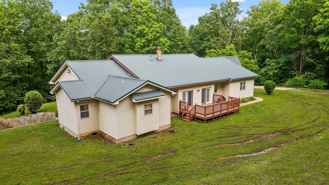 6601 Hunter Rd, Harrison, TN 37341 - rear view of property with a deck, metal roof, a yard, and a chimney