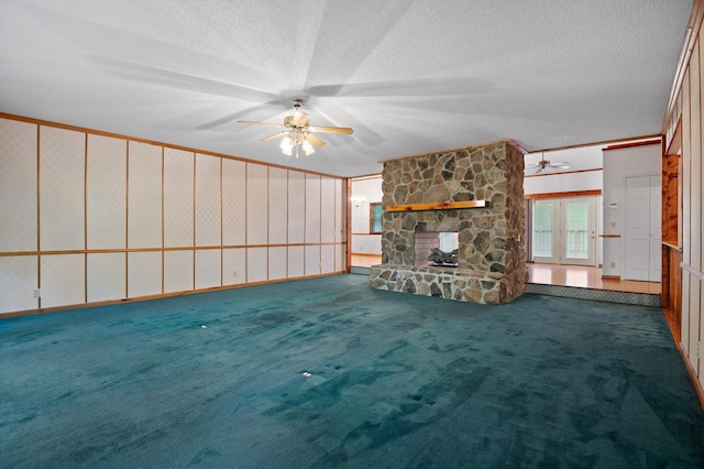 6601 Hunter Rd, Harrison, TN 37341 - unfurnished living room featuring ceiling fan, carpet, a stone fireplace, and a textured ceiling