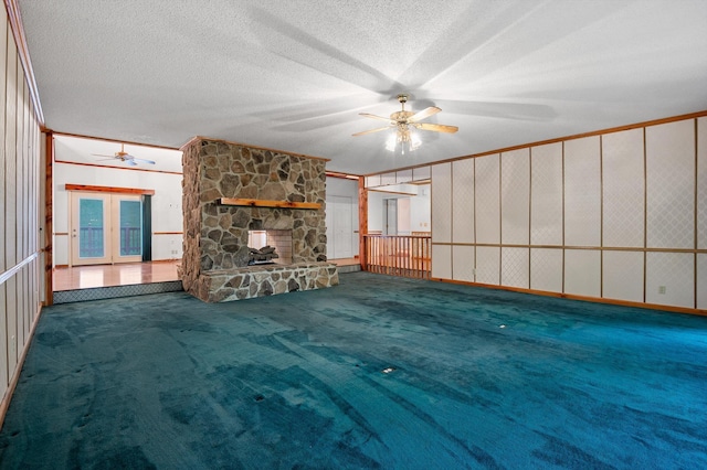 6601 Hunter Rd, Harrison, TN 37341 - unfurnished living room featuring a ceiling fan, carpet floors, a fireplace, a textured ceiling, and french doors