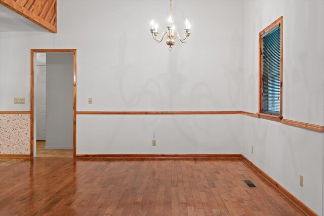 6601 Hunter Rd, Harrison, TN 37341 - empty room featuring a chandelier, wood finished floors, and baseboards