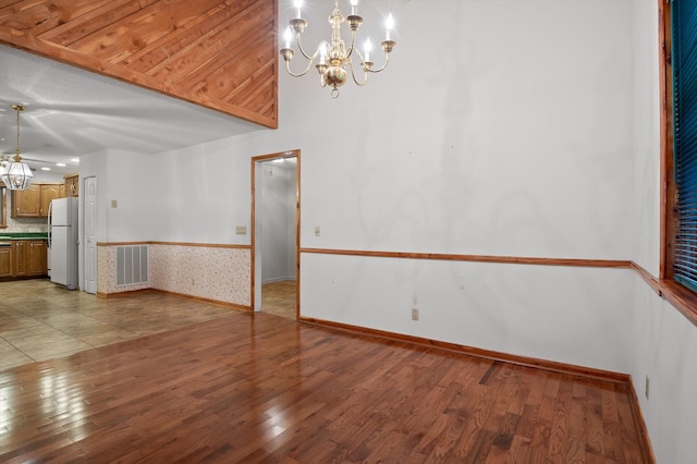 6601 Hunter Rd, Harrison, TN 37341 - unfurnished room featuring a chandelier, light wood-style floors, and baseboards
