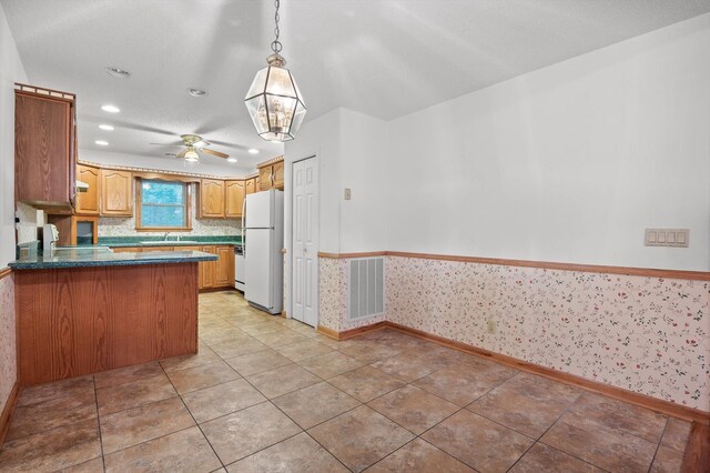 6601 Hunter Rd, Harrison, TN 37341 - kitchen featuring freestanding refrigerator, baseboards, wallpapered walls, a peninsula, and recessed lighting