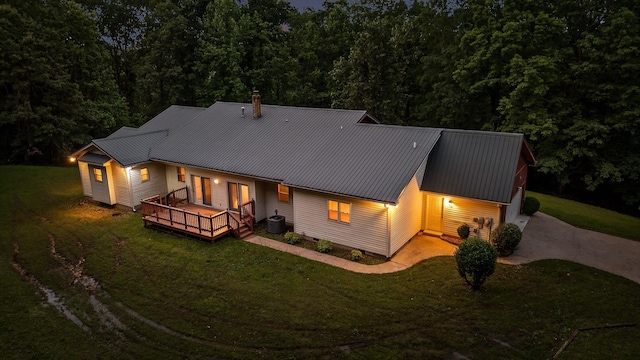 6601 Hunter Rd, Harrison, TN 37341 - rear view of property featuring a lawn, driveway, metal roof, and a wooden deck