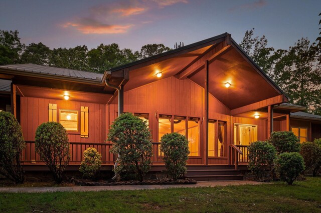 6601 Hunter Rd, Harrison, TN 37341 - back of house at dusk featuring a porch and metal roof