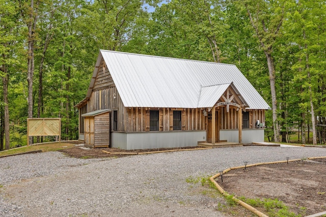 chalet / cabin featuring metal roof and a garage
