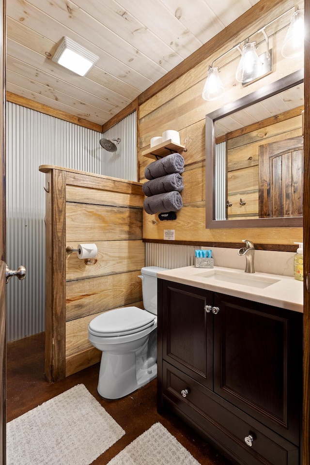bathroom featuring toilet, wooden walls, wooden ceiling, and vanity