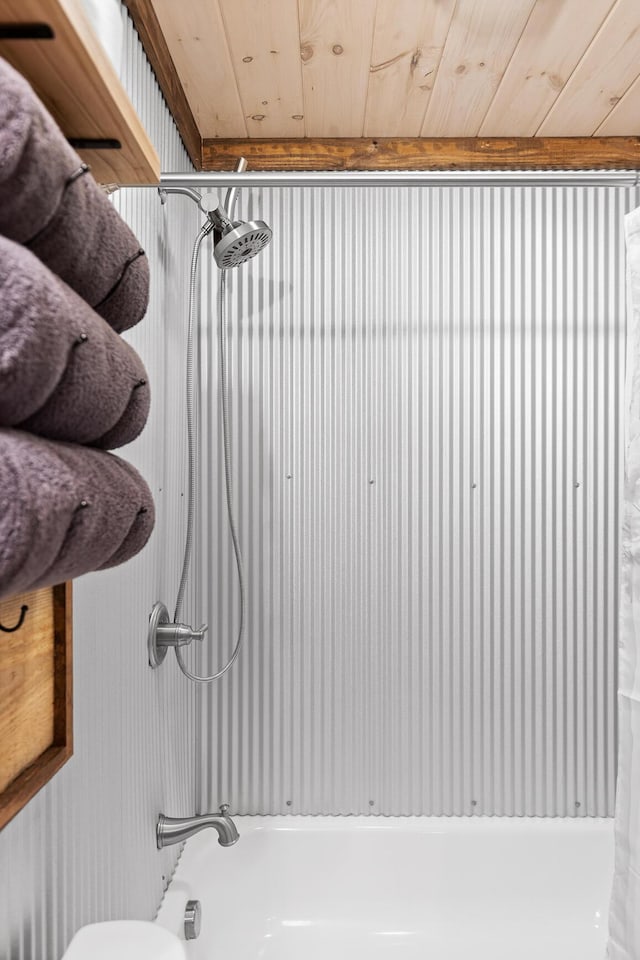 bathroom with wood ceiling, shower / washtub combination, and toilet
