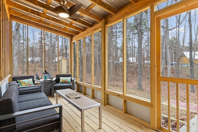 sunroom / solarium featuring a ceiling fan, an outdoor living space, and healthy amount of natural light