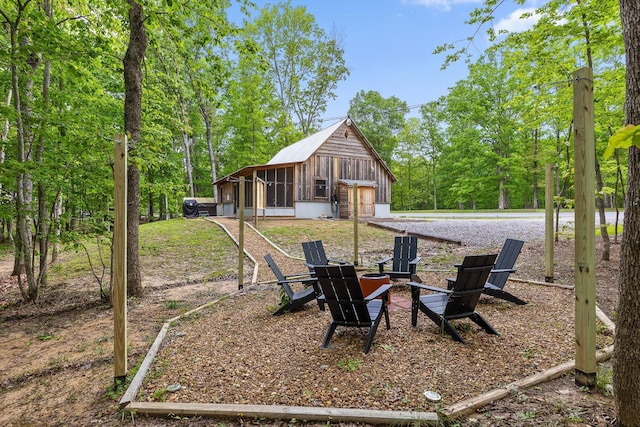 rear view of house with a garage and a fire pit