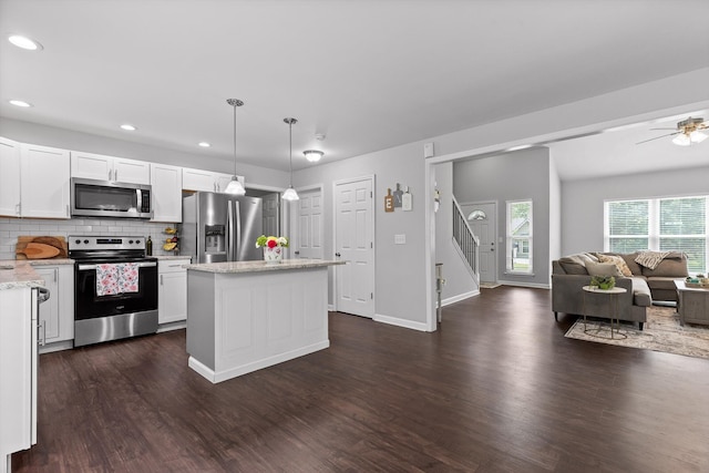 6837 Benwood Dr, Ooltewah, TN 37363 - kitchen with appliances with stainless steel finishes, dark wood-style flooring, open floor plan, white cabinetry, and decorative backsplash