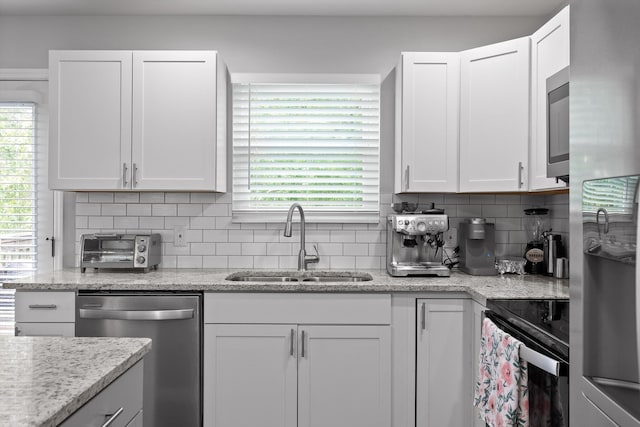 6837 Benwood Dr, Ooltewah, TN 37363 - kitchen featuring stainless steel appliances, a sink, white cabinets, and tasteful backsplash