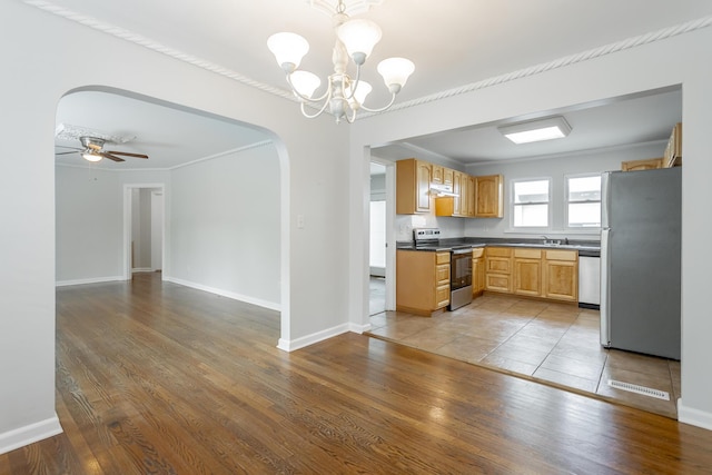 1641 John Ross Rd, Chattanooga, TN 37412 - kitchen featuring stainless steel appliances, arched walkways, under cabinet range hood, a chandelier, and wood finished floors