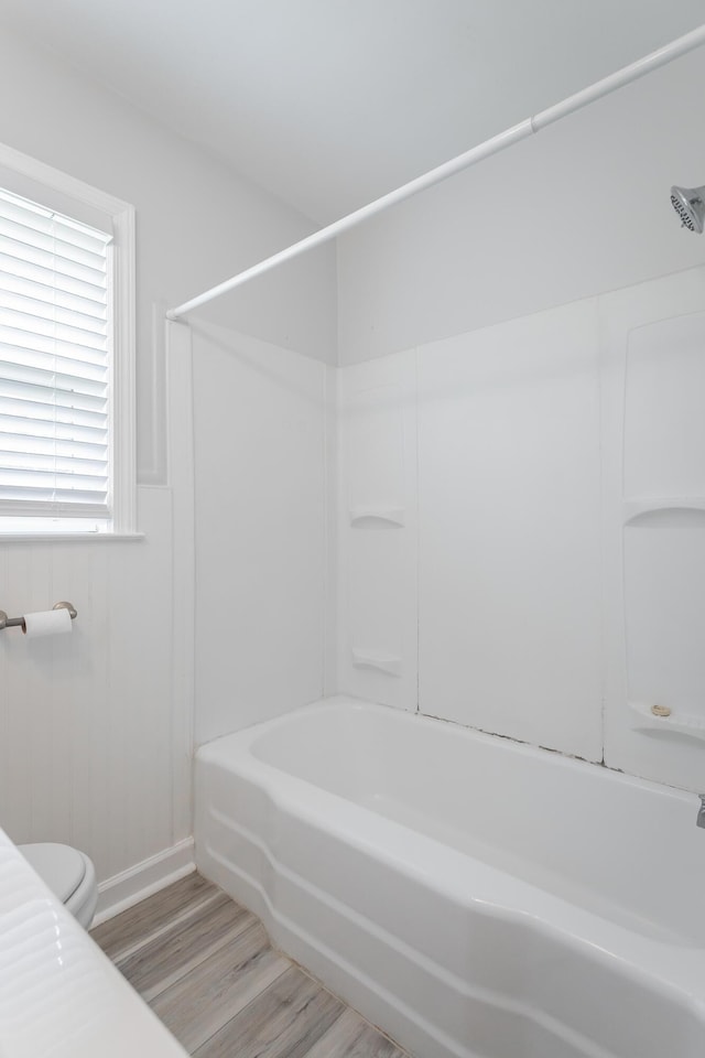 1641 John Ross Rd, Chattanooga, TN 37412 - bathroom with wood finished floors, toilet, a wainscoted wall, and shower / bath combination