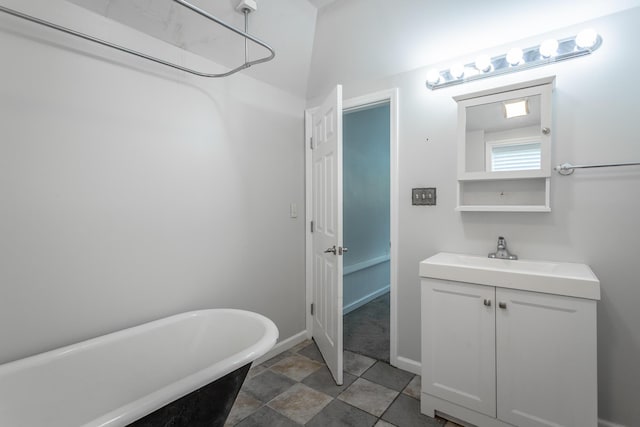 1641 John Ross Rd, Chattanooga, TN 37412 - bathroom with a soaking tub, vanity, and baseboards