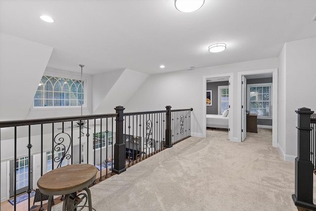 corridor featuring healthy amount of natural light, carpet flooring, baseboards, and recessed lighting