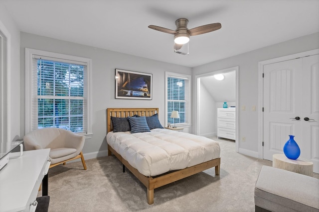 bedroom with light colored carpet, baseboards, and ceiling fan