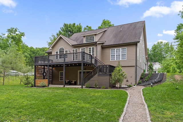 back of property with stairs, a deck, a patio area, and a yard