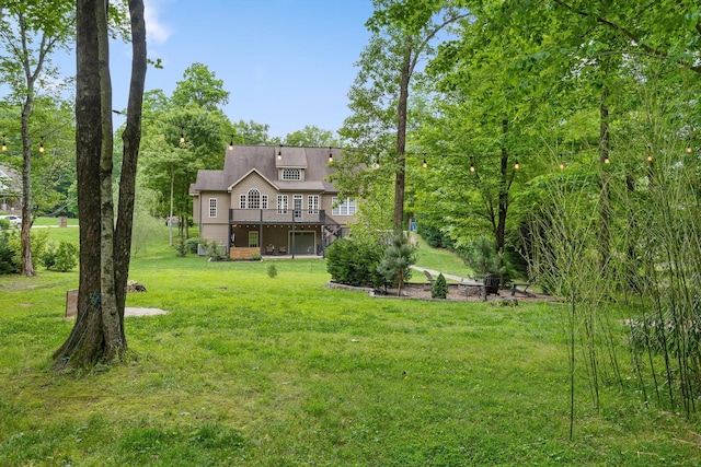 view of green lawn with a deck